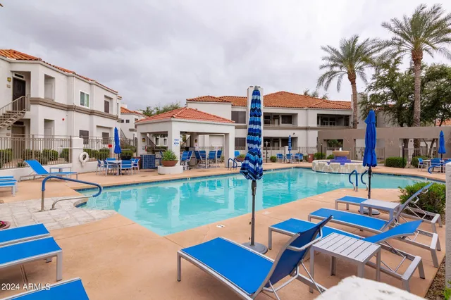 a room with pool table and windows
