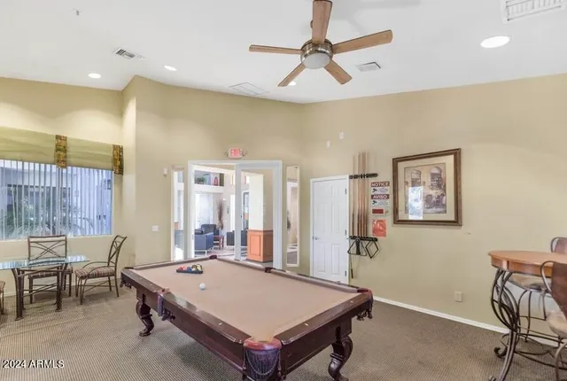 a kitchen with a table chairs and entryway
