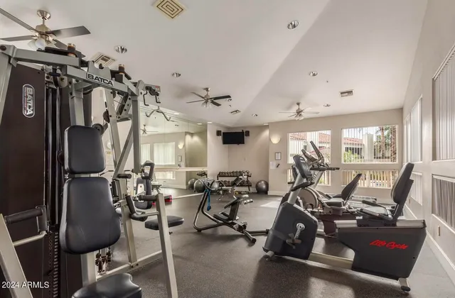 a living room with furniture large window and flat screen tv