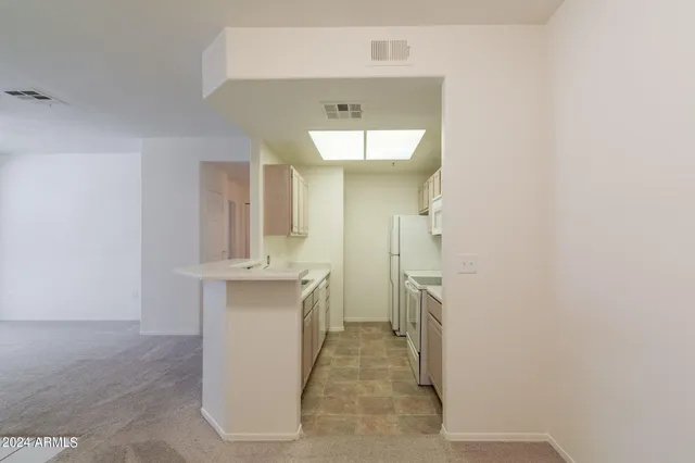 a kitchen with a sink cabinets and utility