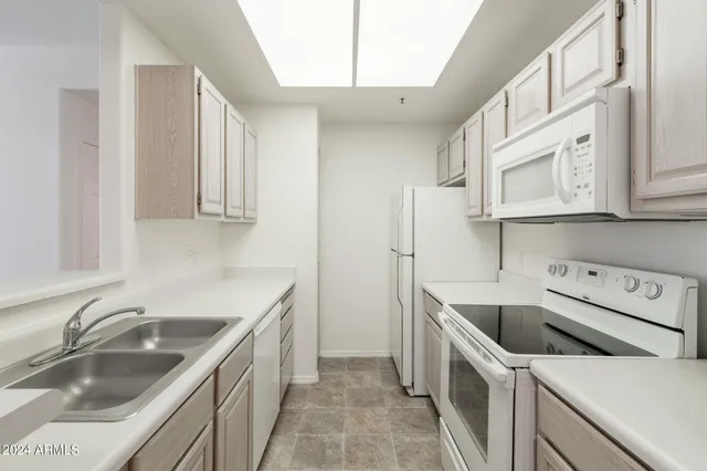 a kitchen with stainless steel appliances granite countertop a sink stove and cabinets