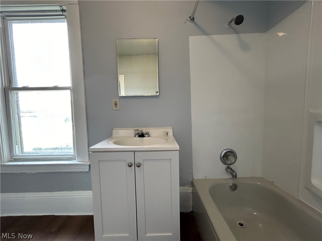 3403 Fulton Road, Unit DOWN Cleveland, OH 44109 - Photo 14 of 18 Bathroom featuring vanity, hardwood / wood-style flooring, and bathing tub / shower combination