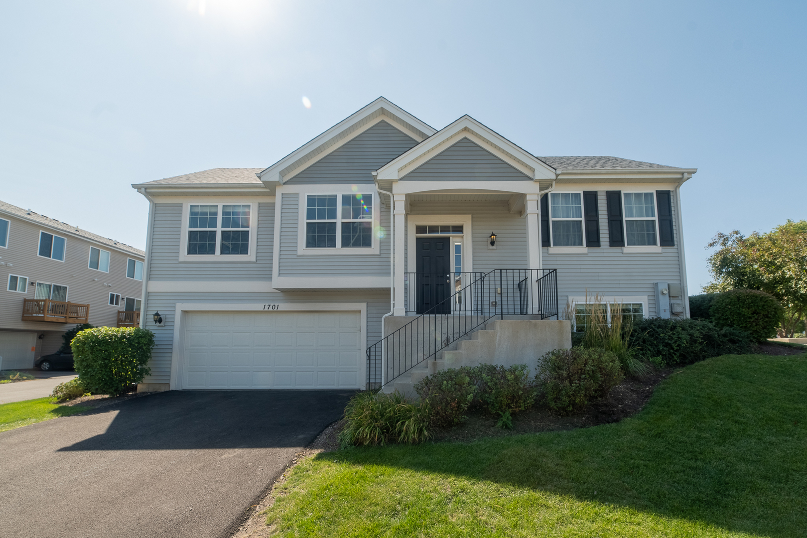 1701 Windward Drive Pingree Grove, IL 60140 - Photo 1 of 19 a front view of a house with garden