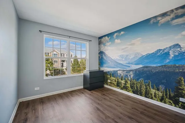 wooden floor in a room next to a window
