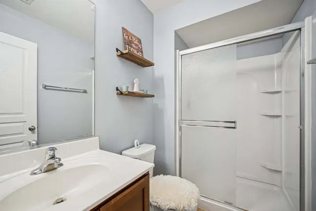 a bathroom with a sink mirror vanity and toilet