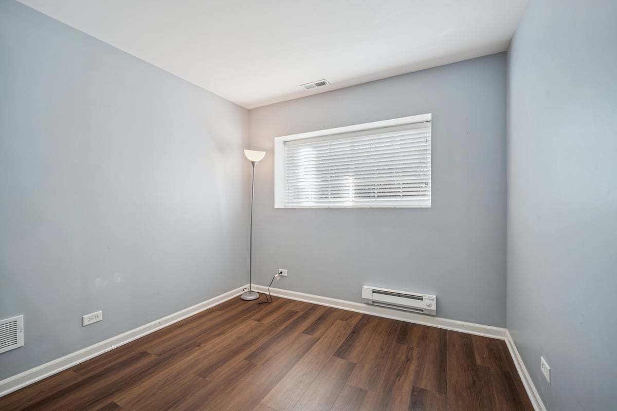 1701 Windward Drive Pingree Grove, IL 60140 - Photo 15 of 19 an empty room with wooden floor and windows