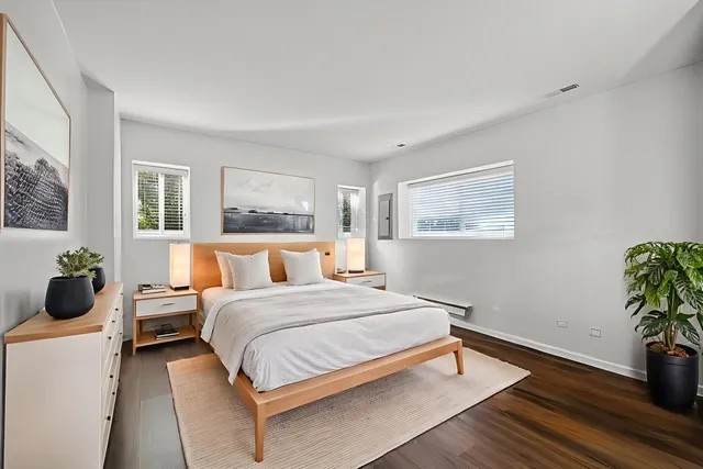 a bedroom with a bed and wooden floor