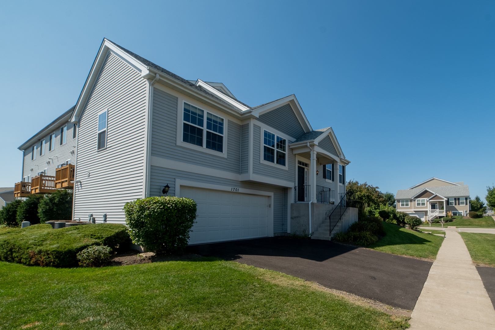 1701 Windward Drive Pingree Grove, IL 60140 - Photo 18 of 19 a front view of a house with a garden