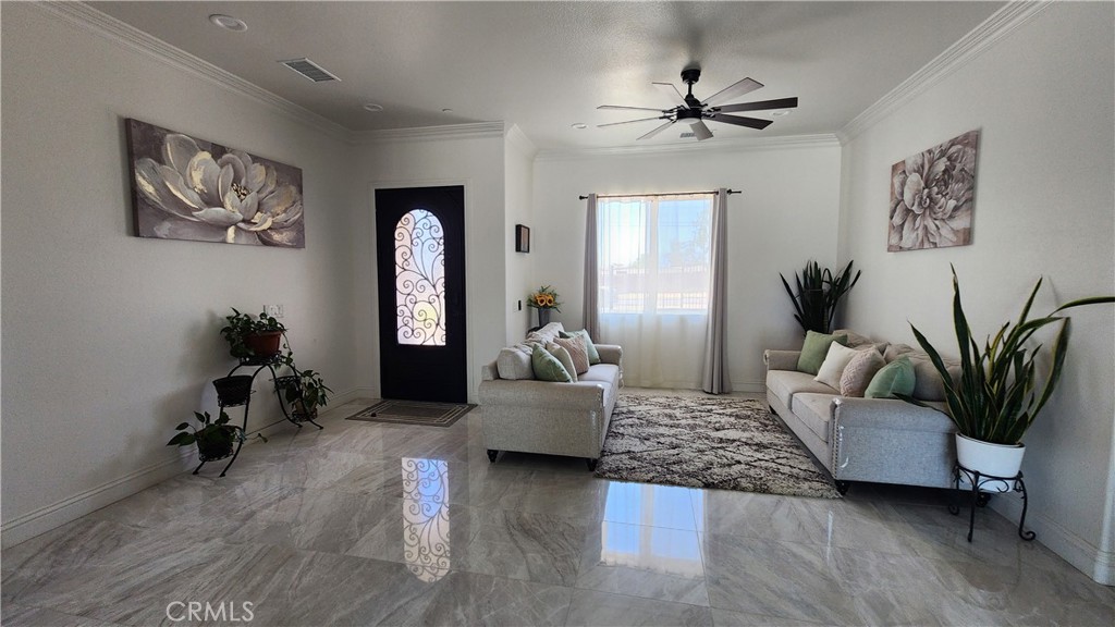20243 Lee Road Perris, CA 92570 - Photo 25 of 75 a living room with furniture and a potted plant