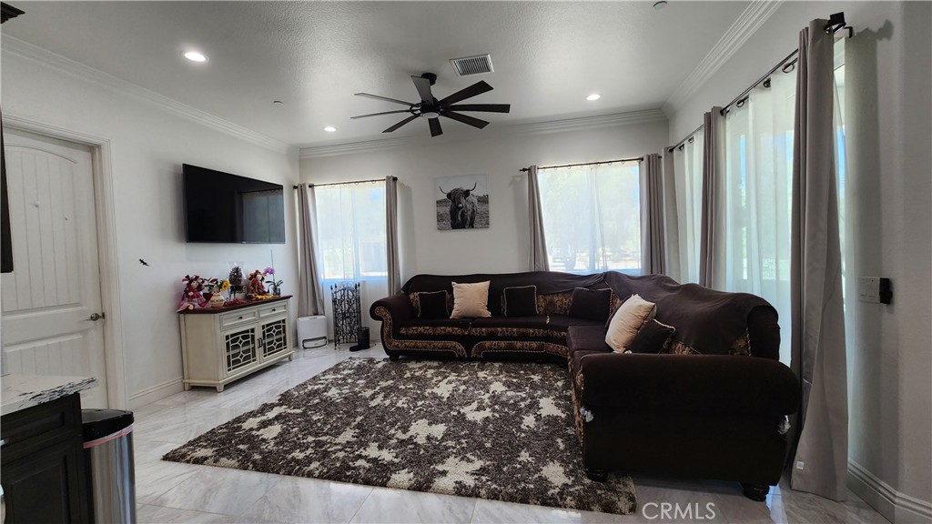 20243 Lee Road Perris, CA 92570 - Photo 26 of 75 a living room with furniture and a flat screen tv