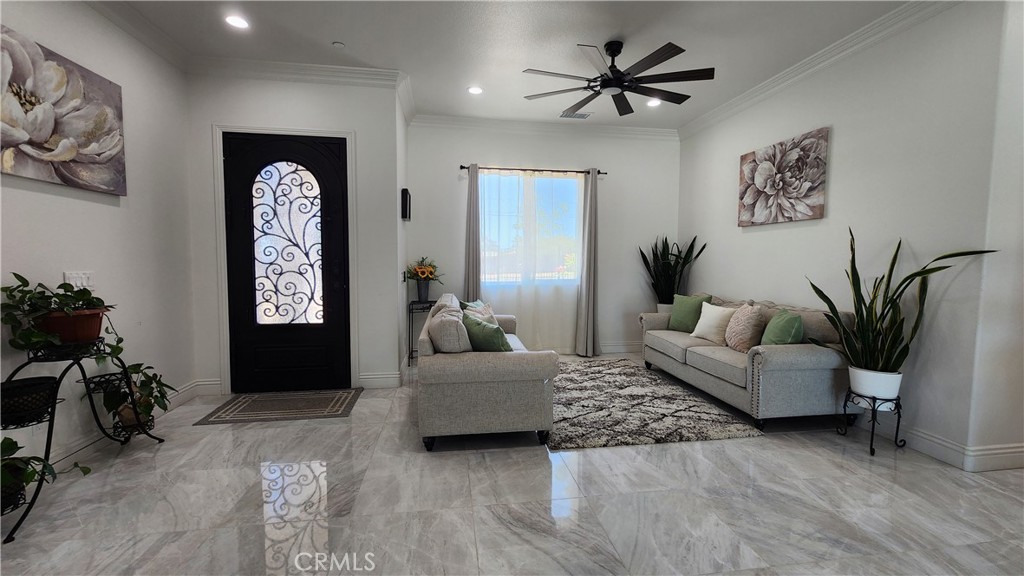 20243 Lee Road Perris, CA 92570 - Photo 29 of 75 a living room with furniture and a chandelier