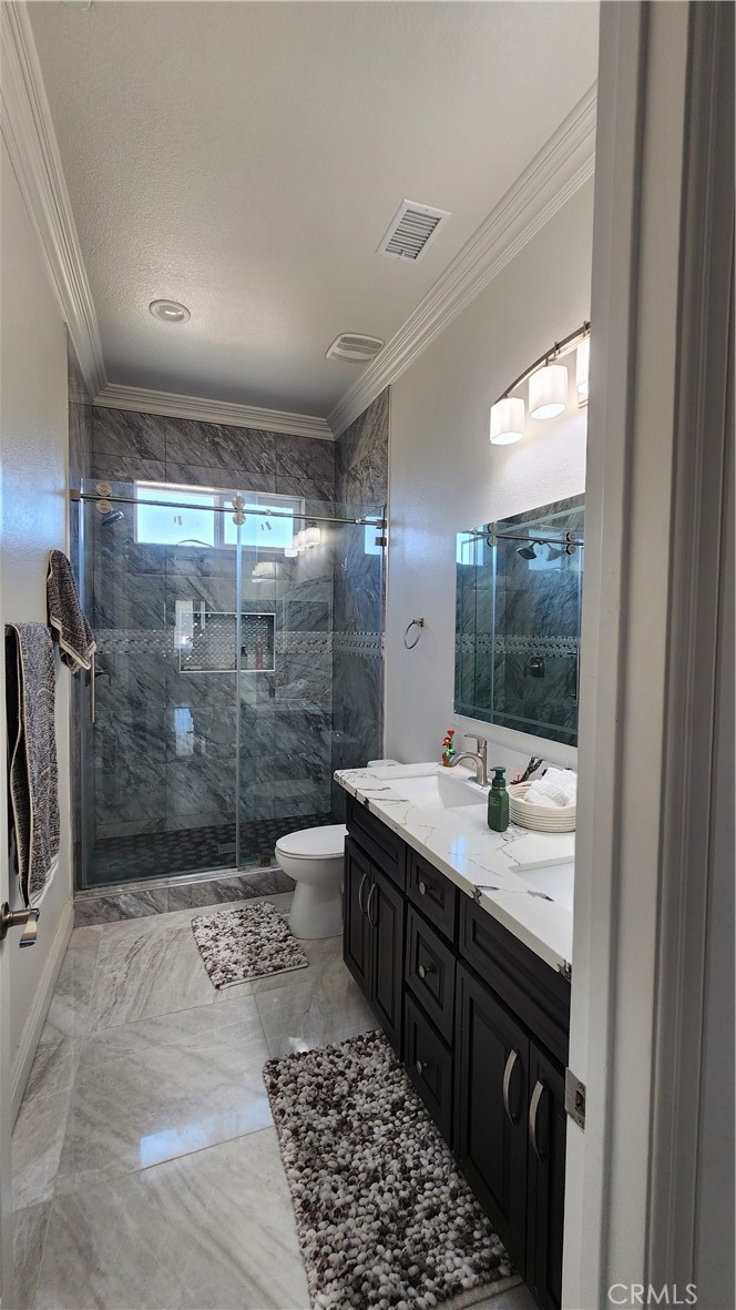 20243 Lee Road Perris, CA 92570 - Photo 43 of 75 a bathroom with a double vanity sink toilet and shower