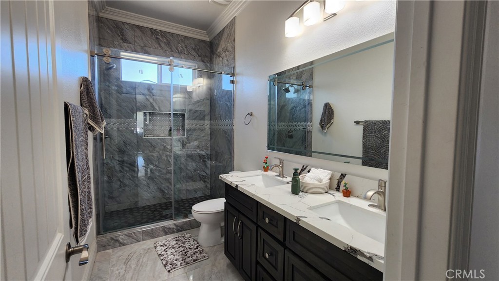 20243 Lee Road Perris, CA 92570 - Photo 44 of 75 a bathroom with a double vanity sink toilet and shower