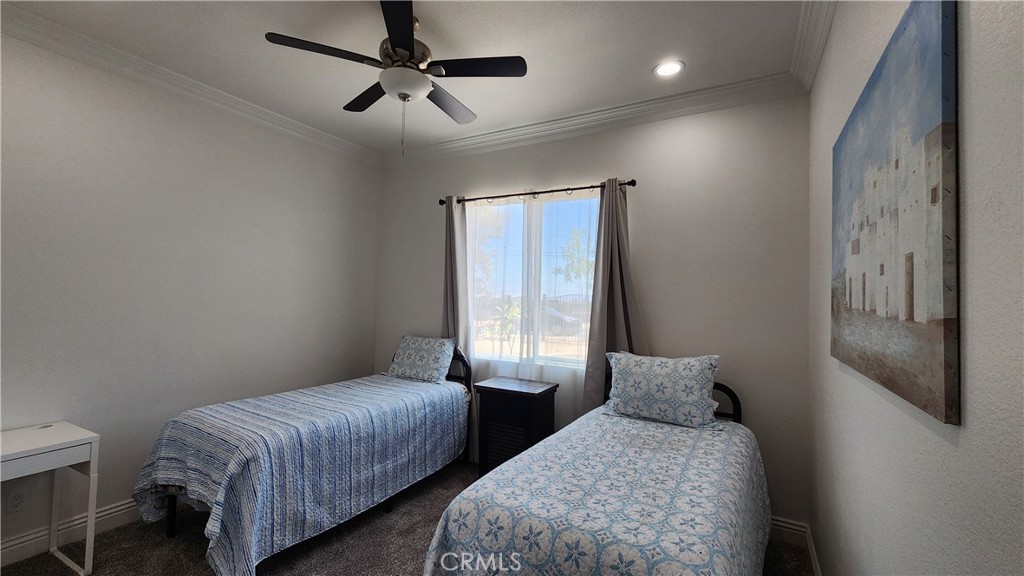 20243 Lee Road Perris, CA 92570 - Photo 50 of 75 a bedroom with two beds and ceiling fan