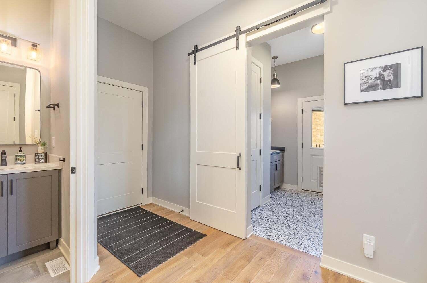 16617 Noble Street Lowell, IN 46356 - Photo 12 of 32 a view of a hallway with wooden floor and a bathroom