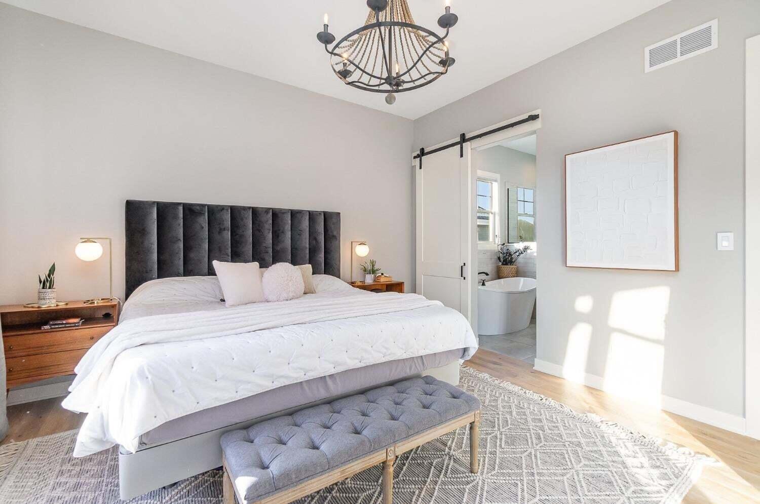 16617 Noble Street Lowell, IN 46356 - Photo 20 of 32 a bedroom with a bed and a chandelier