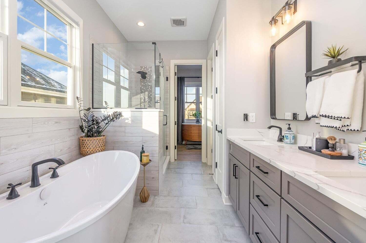 16617 Noble Street Lowell, IN 46356 - Photo 23 of 32 a bathroom with a granite countertop sink mirror and a bathtub