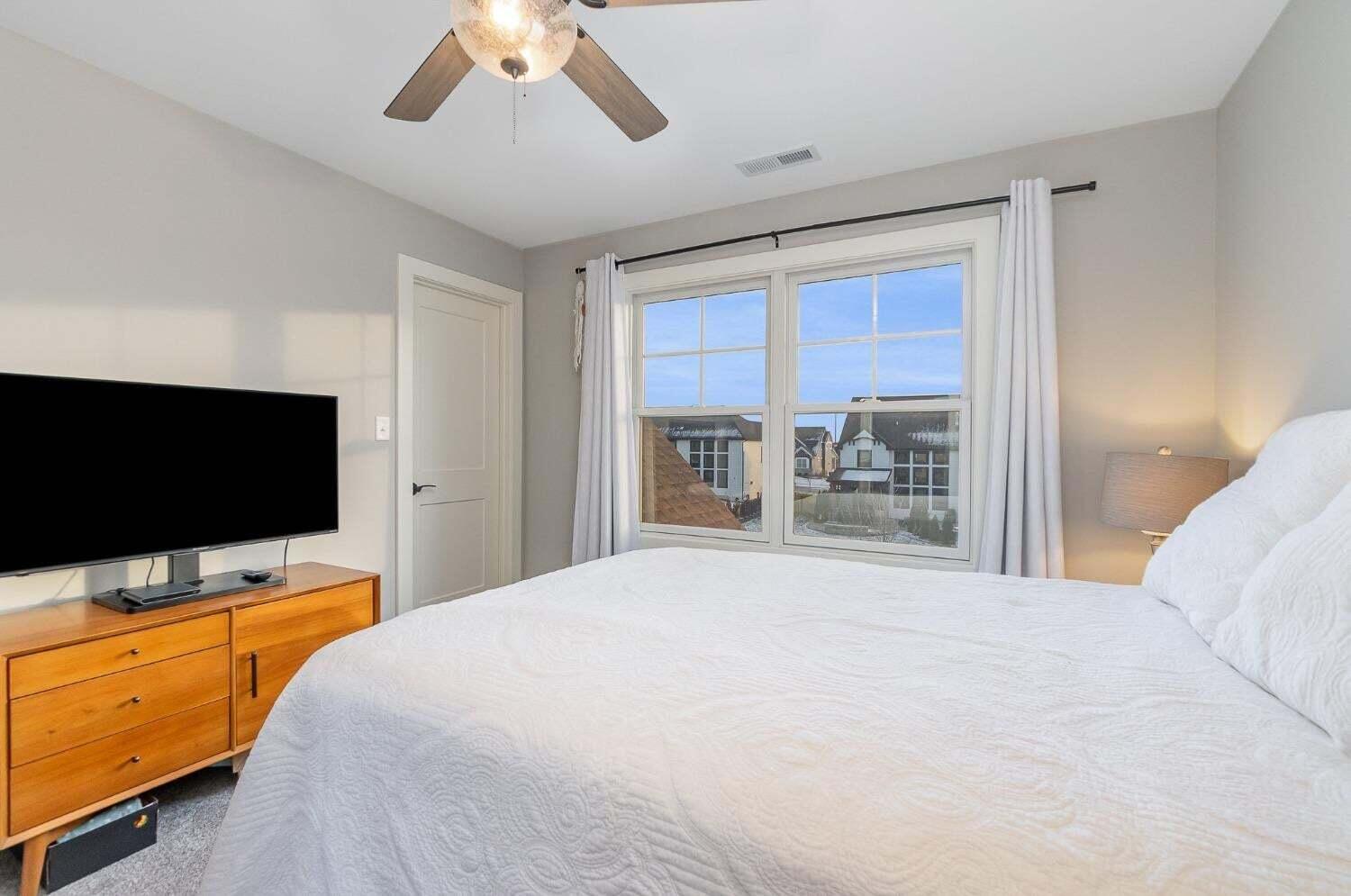 16617 Noble Street Lowell, IN 46356 - Photo 25 of 32 a bedroom with a bed and a flat tv screen on dresser