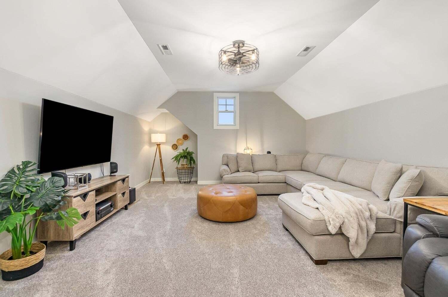 16617 Noble Street Lowell, IN 46356 - Photo 29 of 32 a living room with furniture and a flat screen tv