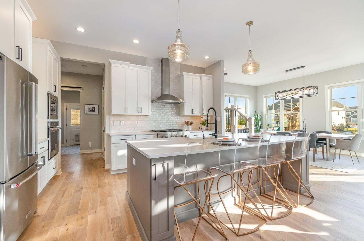 16617 Noble Street Lowell, IN 46356 - Photo 9 of 32 a large kitchen with kitchen island a large island in it