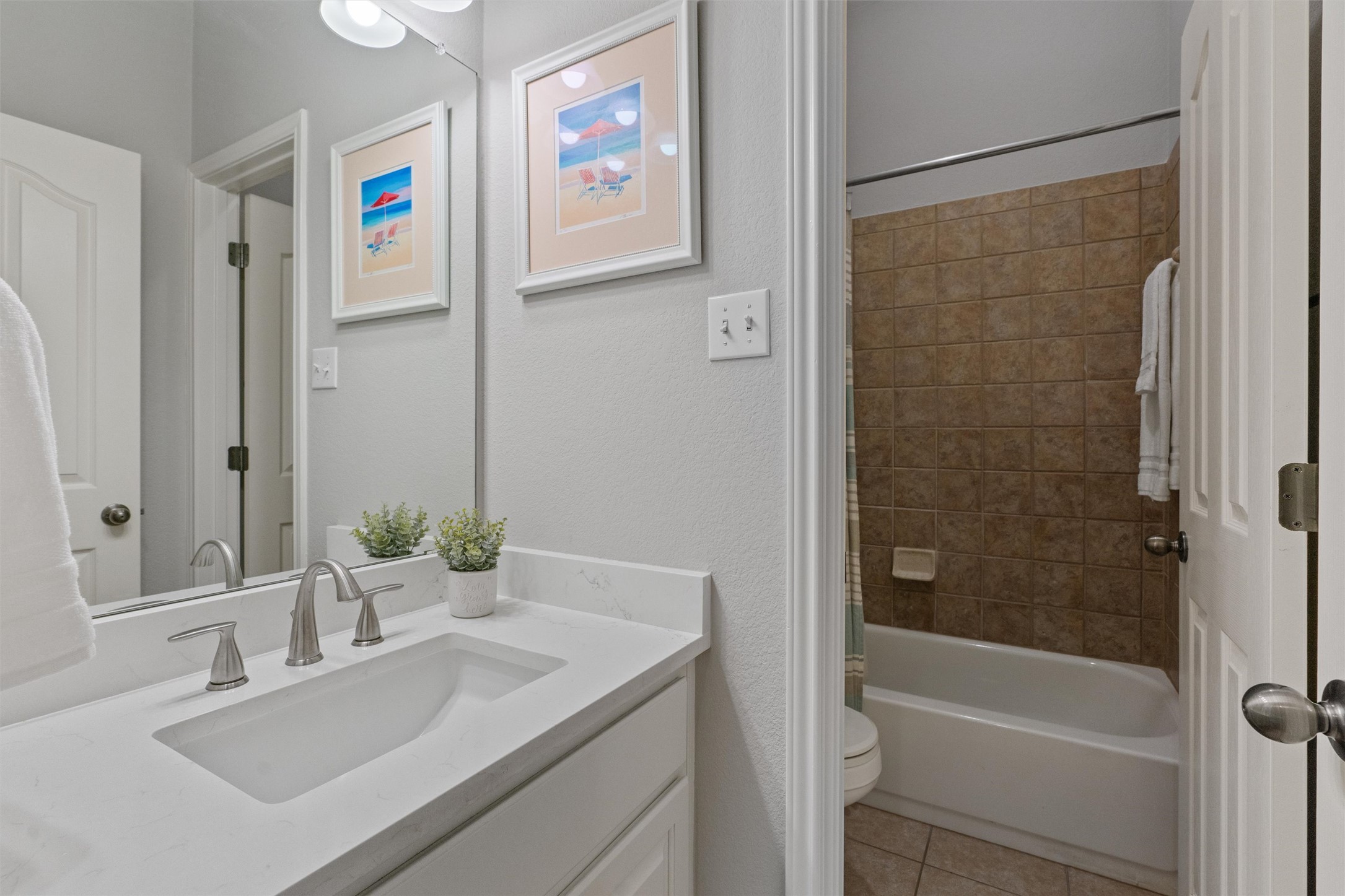 3736 Cerulean Way Round Rock, TX 78681 - Photo 13 of 36 Bathroom featuring vanity, light tile patterned flooring, shower / bath combo, and a textured wall