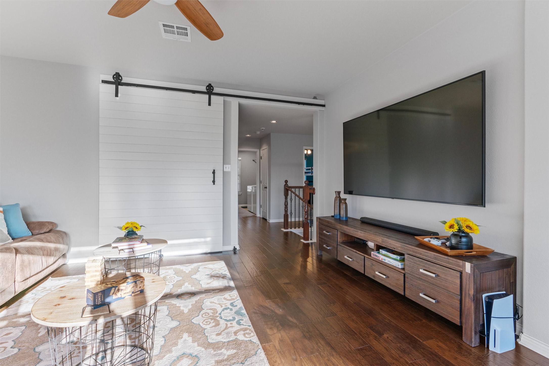 3736 Cerulean Way Round Rock, TX 78681 - Photo 18 of 36 Living room featuring dark wood finished floors, a barn door, and ceiling fan