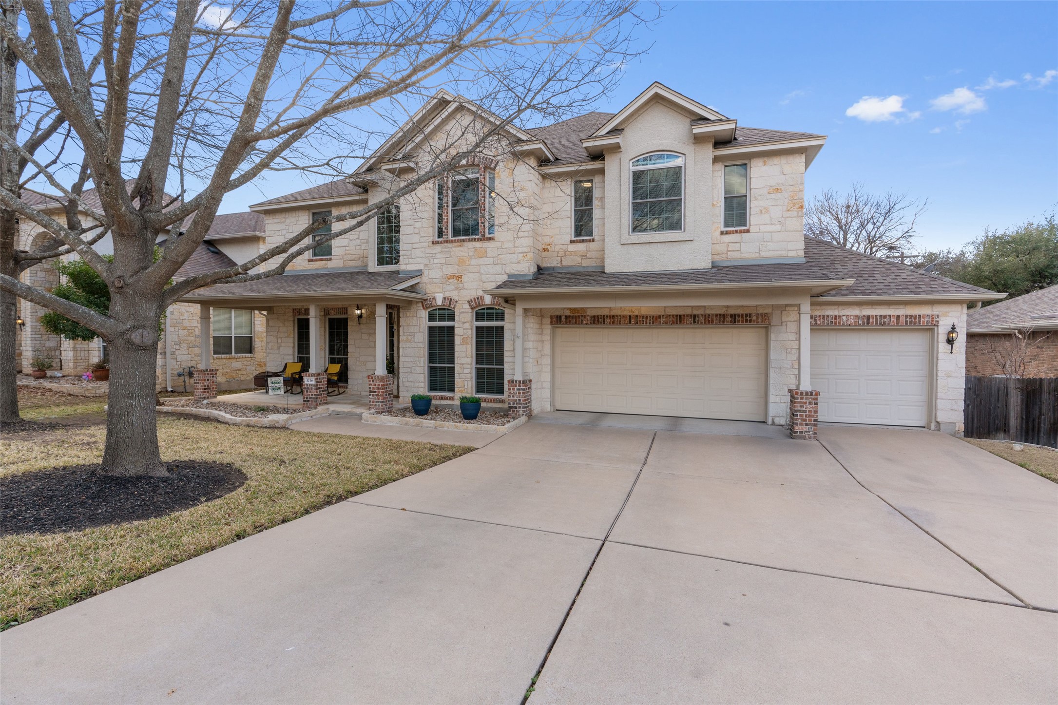 3736 Cerulean Way Round Rock, TX 78681 - Photo 2 of 36 View of front of home with stone siding, a shingled roof, an attached garage, concrete driveway, and a porch