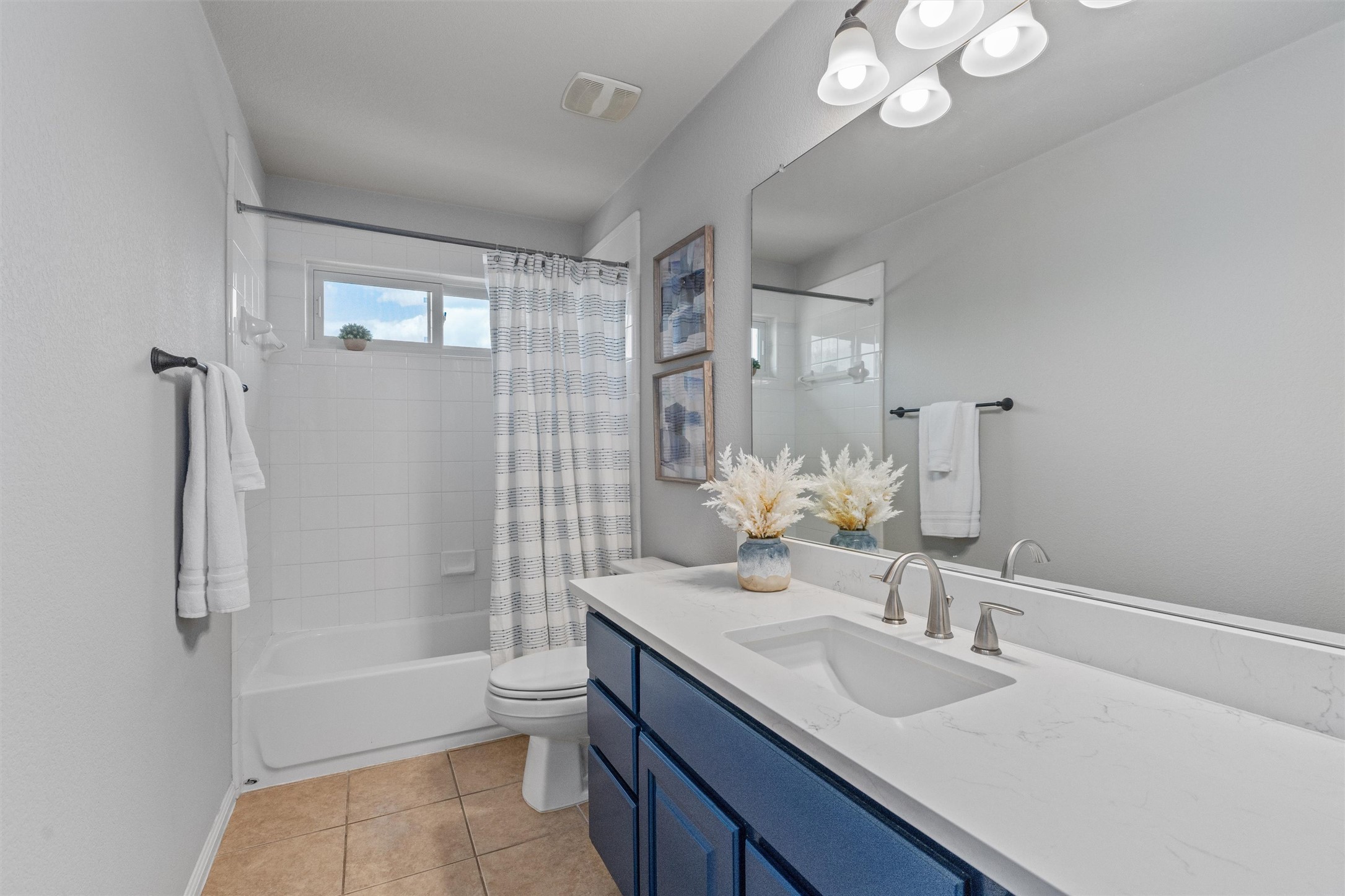 3736 Cerulean Way Round Rock, TX 78681 - Photo 26 of 36 Bathroom featuring shower / bath combo with shower curtain, vanity, and light tile patterned floors