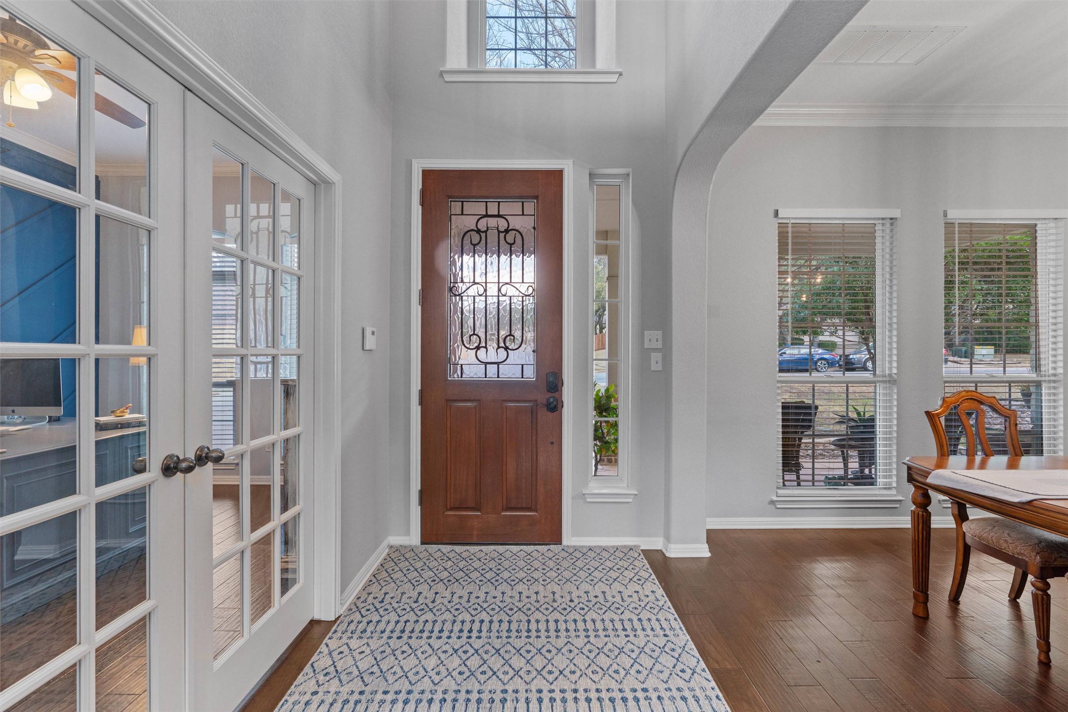 3736 Cerulean Way Round Rock, TX 78681 - Photo 6 of 36 Foyer entrance with crown molding, french doors, arched walkways, and dark wood-style floors
