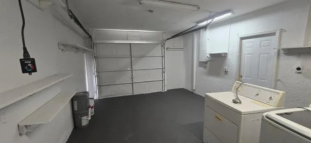 a backyard of a house with table and chairs