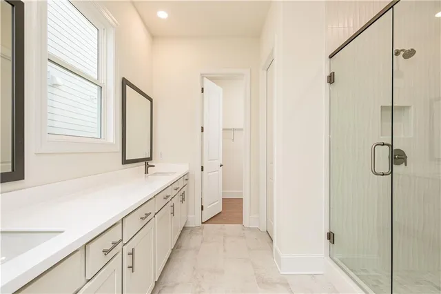 a bathroom with a granite countertop sink a mirror and a bathtub