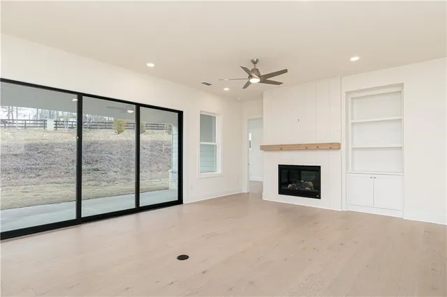 a view of an empty room with a fireplace