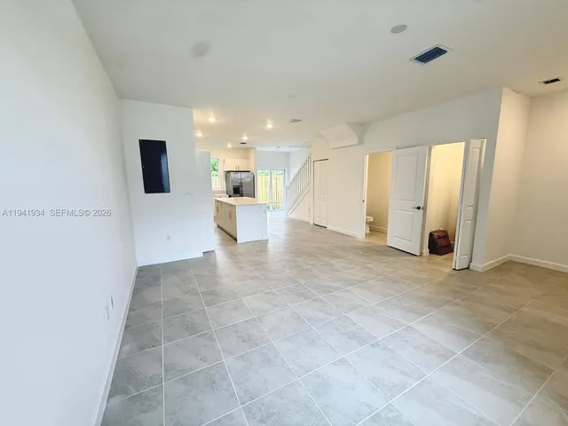 a view of a big room with closet and windows