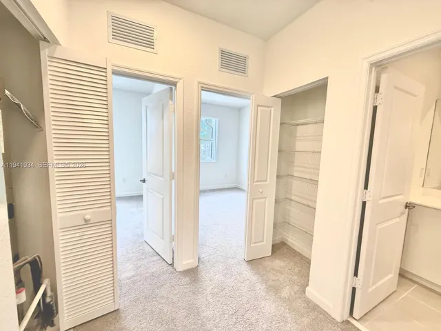 a view of a kitchen with furniture and floor to ceiling window