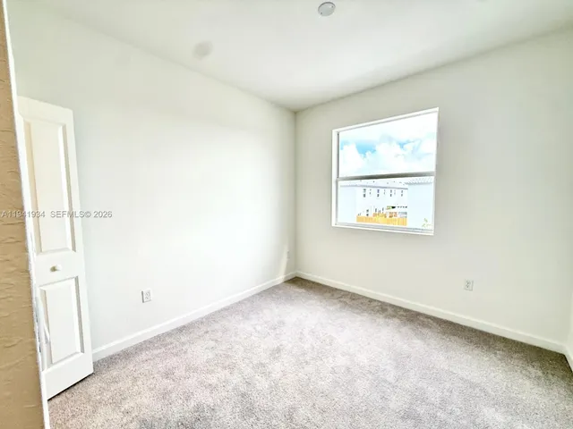 a bathroom with a tub and a glass door