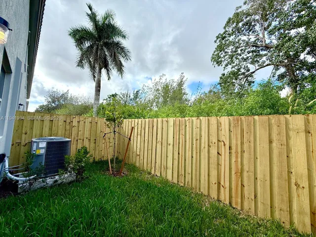a small yard with a wooden fence