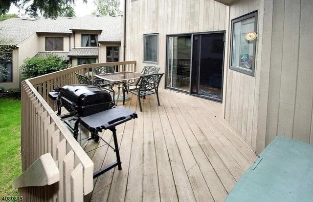 a roof deck with table and chairs