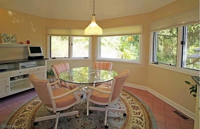 a dining room with furniture window and wooden floor