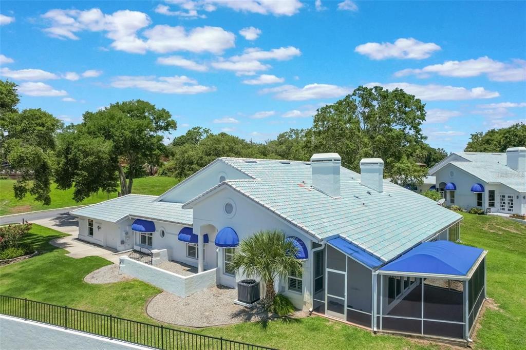 a aerial view of a house with swimming pool garden view and a tree