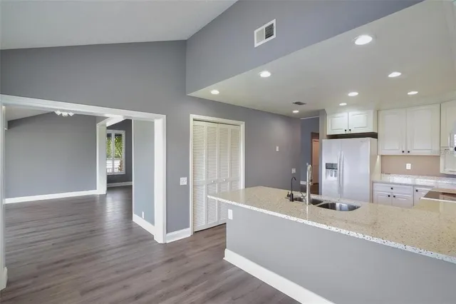 a view of a kitchen and wooden floor