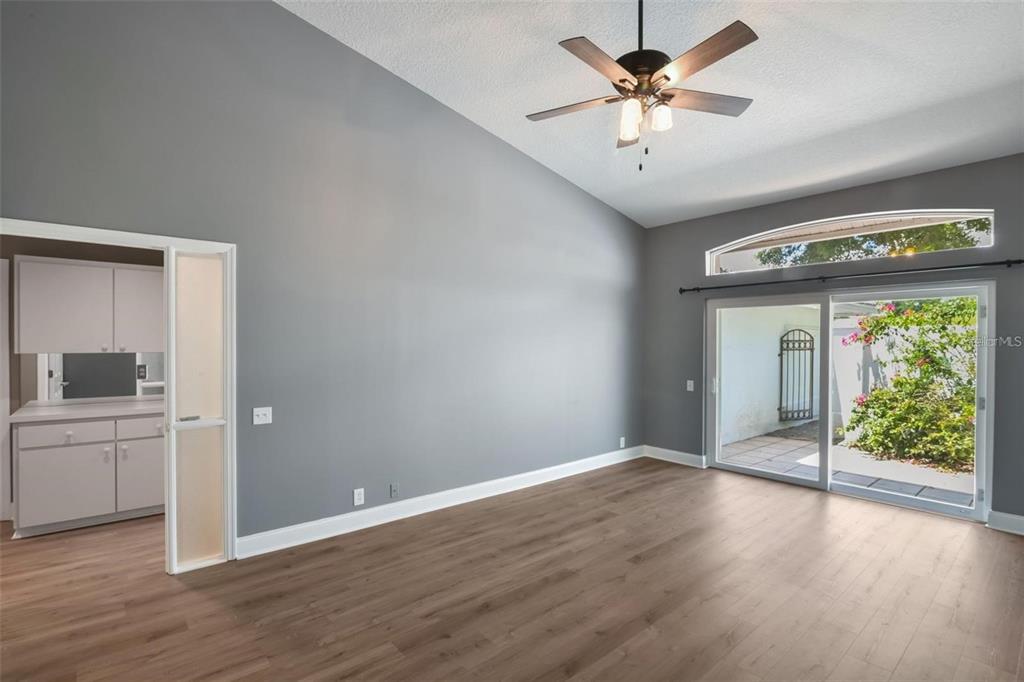 6036 Topsail Road Lady Lake, FL 32159 - Photo 30 of 35 a view of an empty room with a window and wooden floor