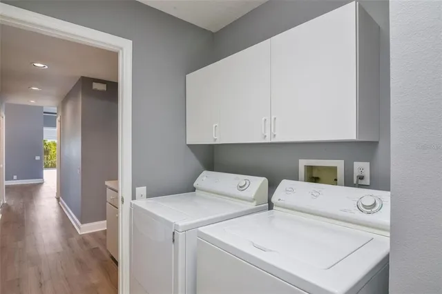 a view of washer and dryer with kitchen in the background