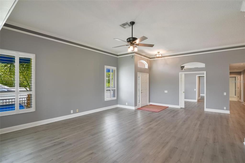 6036 Topsail Road Lady Lake, FL 32159 - Photo 10 of 35 a view of an empty room with wooden floor and a window