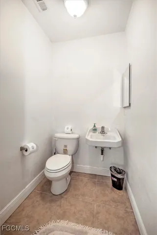 a bathroom with a sink a toilet and a window