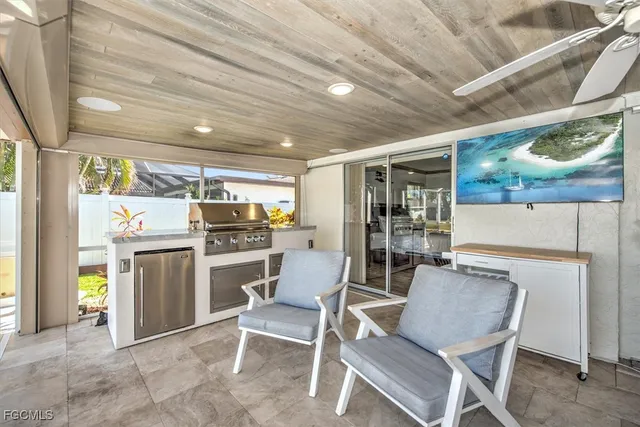 a kitchen with a dining table chairs and refrigerator