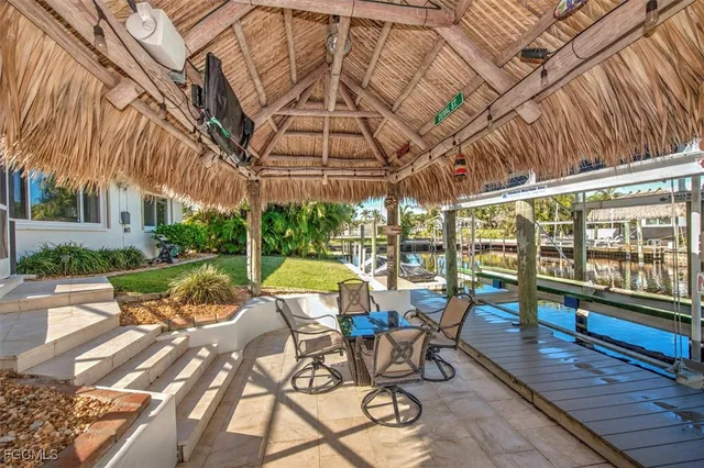 a view of a patio with table and chairs and potted plants