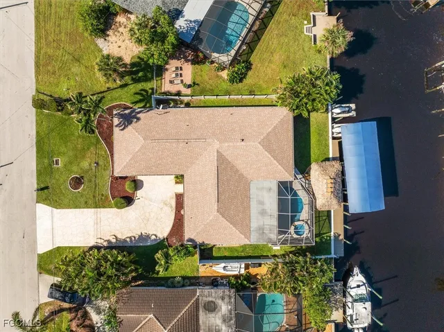 an aerial view of a house with a yard and garden