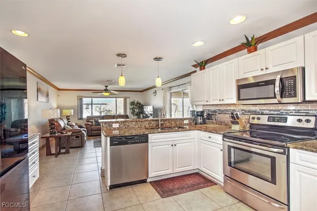 a kitchen with appliances a sink and cabinets