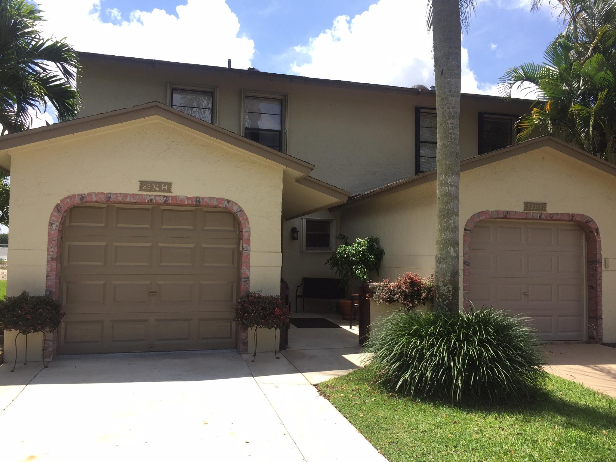 8904 Southwest 22nd Street, Unit H Boca Raton, FL 33433 - Photo 1 of 30 a front view of house with yard