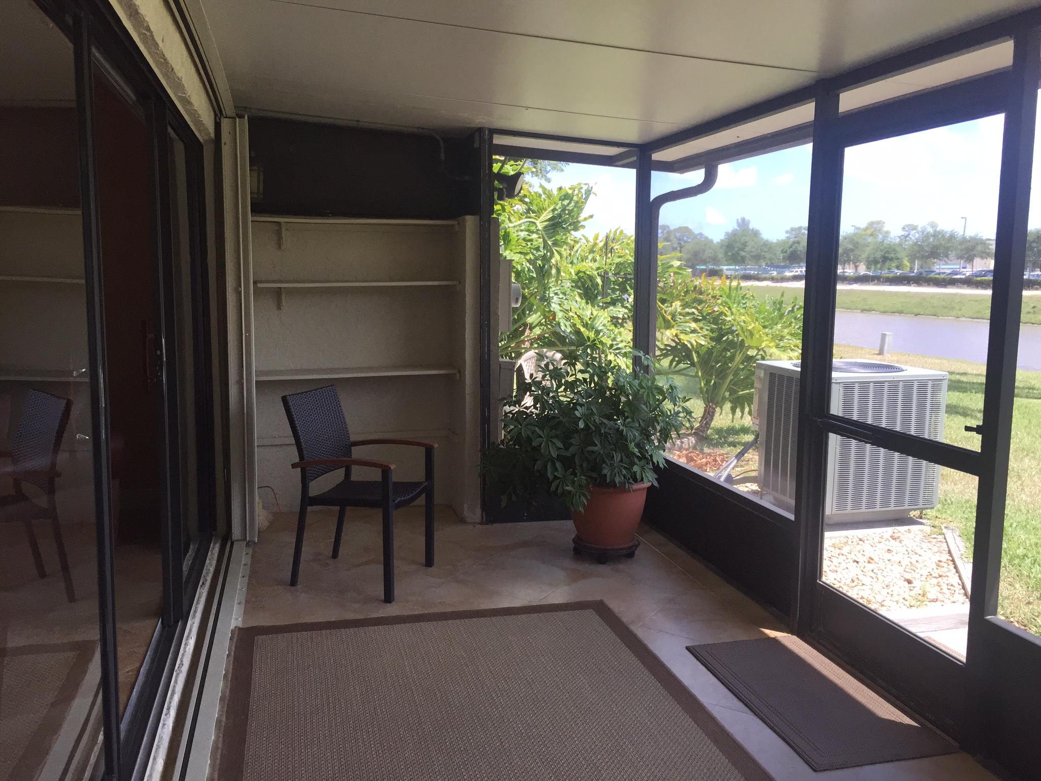 8904 Southwest 22nd Street, Unit H Boca Raton, FL 33433 - Photo 12 of 30 a view of a porch with furniture and floor to ceiling window